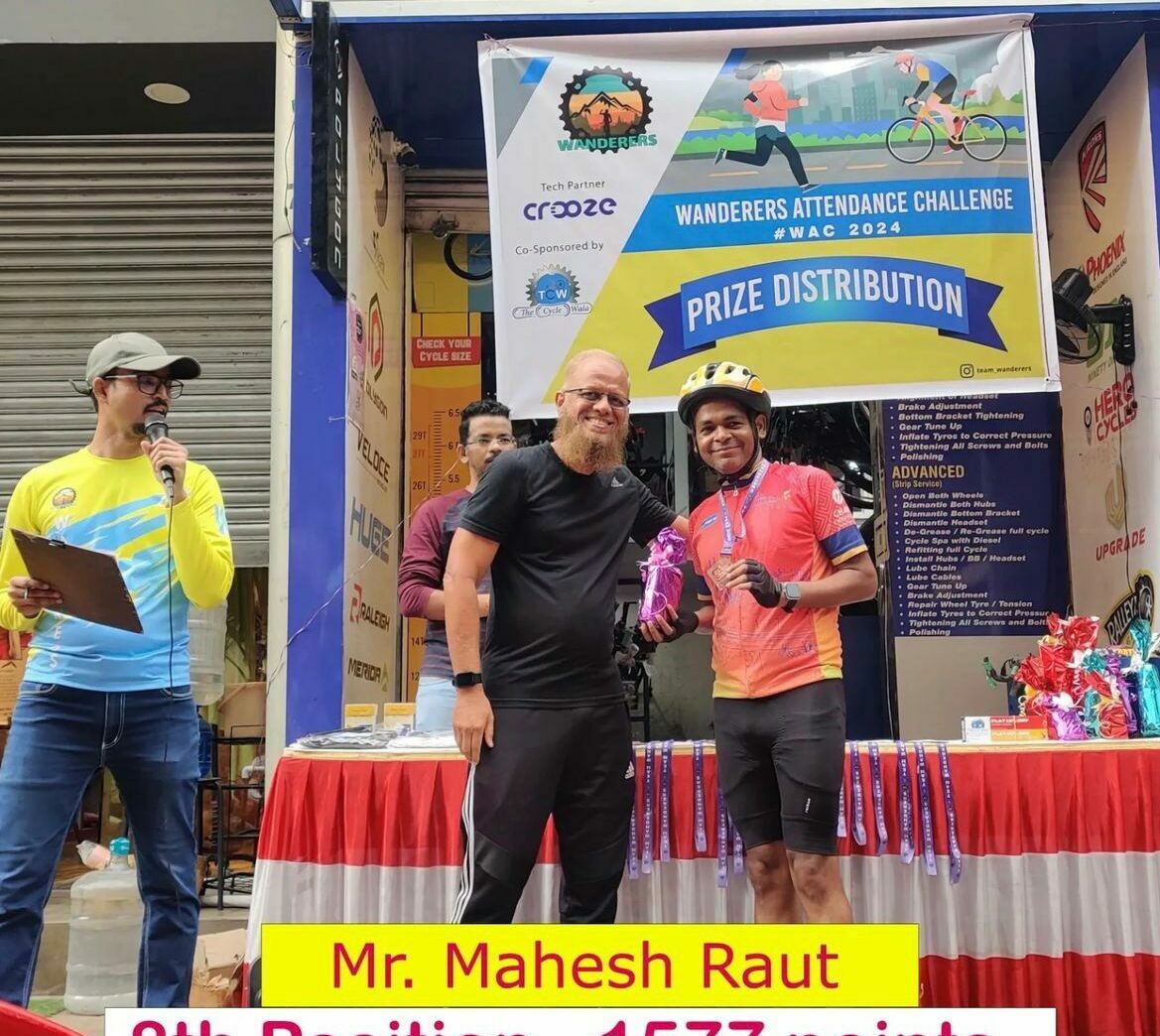 a cyclist getting an award for winning the cycling marathon for a social cause sponsored by our cycle shop.